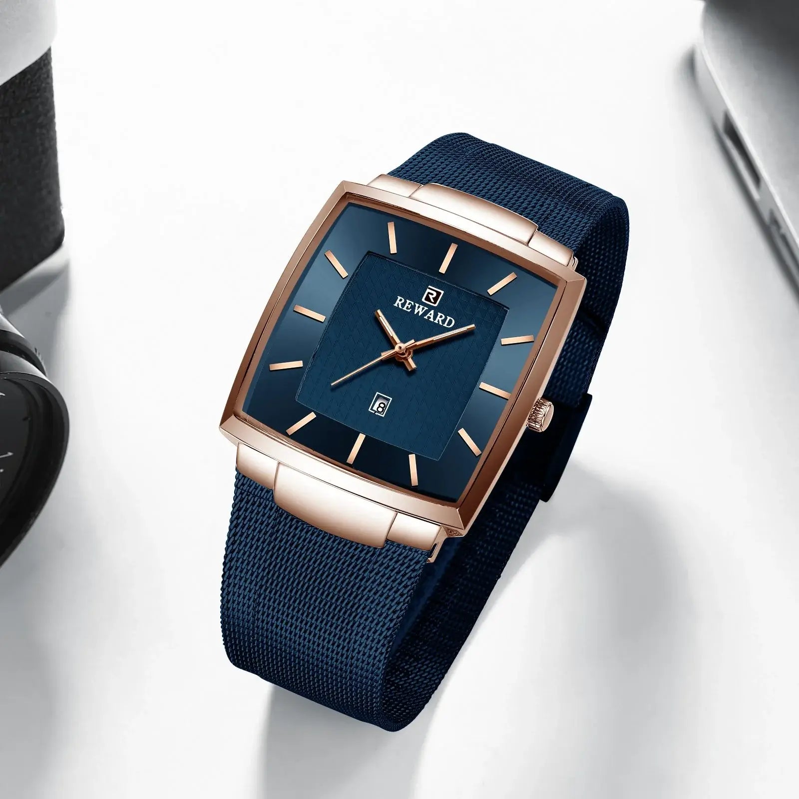 Blue watch with rose gold accents on a white background