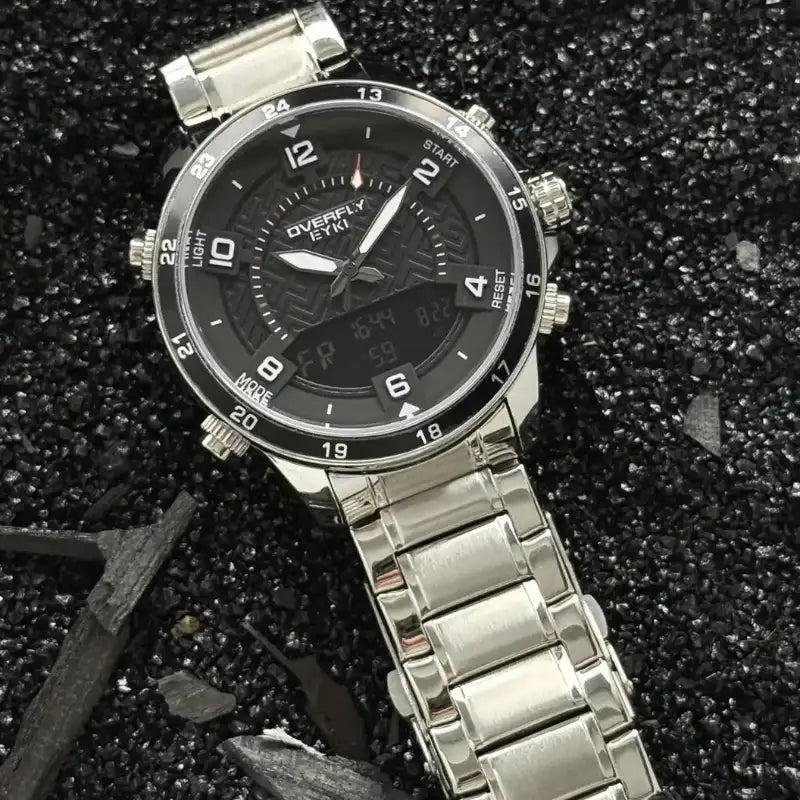 Polished silver stainless steel multifunctional men's watch on dark gravel. Best affordable watches at our online watch store in Canada.