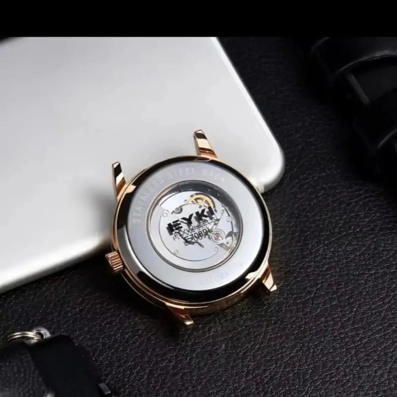 Watch with a detailed mechanical design on a dark surface