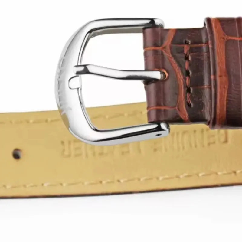 Close-up of a brown leather belt with a silver buckle on a white background