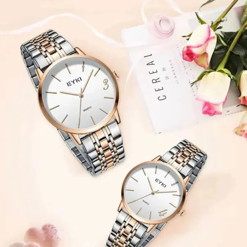 Two watches with rose gold and silver bands on a light background with flowers.