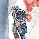 Blue watch with a detailed face on a blurred background