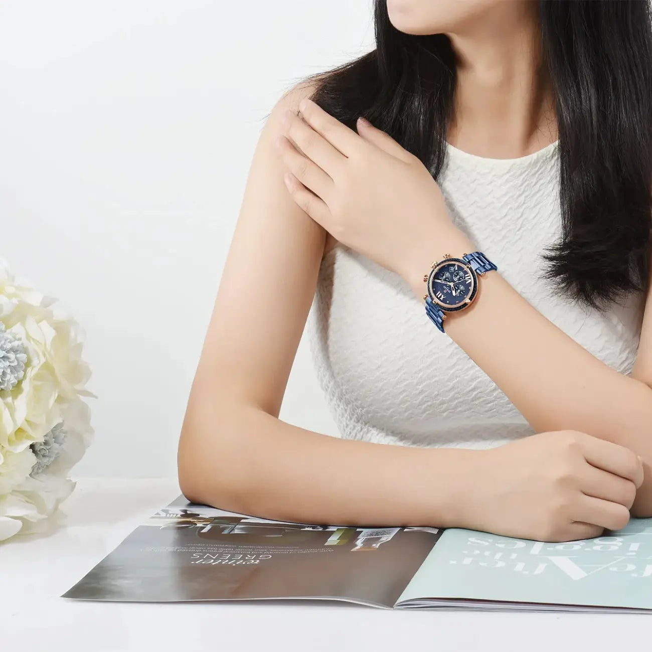 Woman wearing a blue watch on a white background