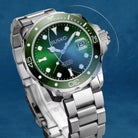 Silver watch with a green face on a blue background