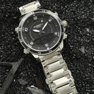 Polished silver stainless steel multifunctional men's watch on dark gravel. Best affordable watches at our online watch store in Canada.