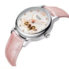 Wristwatch with pink strap and decorative face on a white background