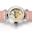 Watch with pink strap and visible mechanical components on a white background
