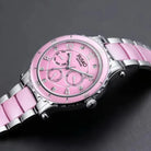 Pink watch with silver accents on a dark background