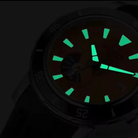 Watch face with glowing green hour markers on a dark background