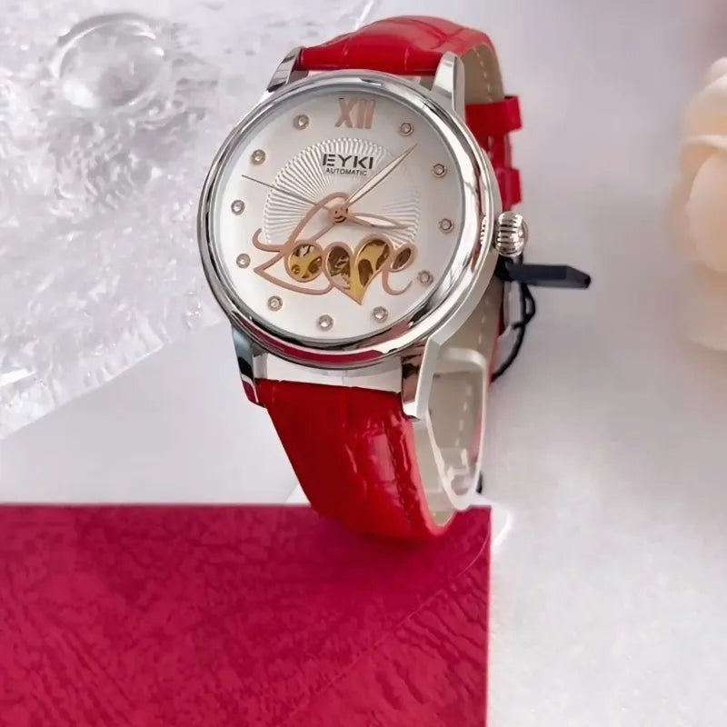 Wristwatch with red strap and decorative face on a white background