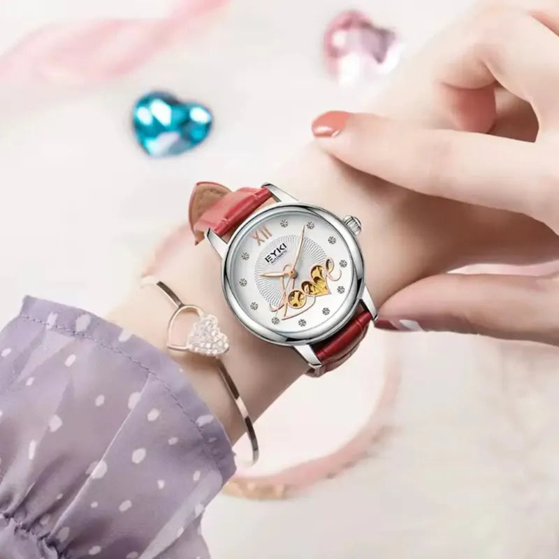Wristwatch with red strap worn on a wrist, with a soft pink background