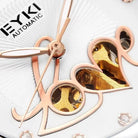 Close-up of a watch with rose gold and gold components, featuring the brand 'EYKI'.