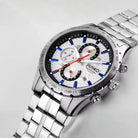 Silver watch with a detailed face on a light gray background