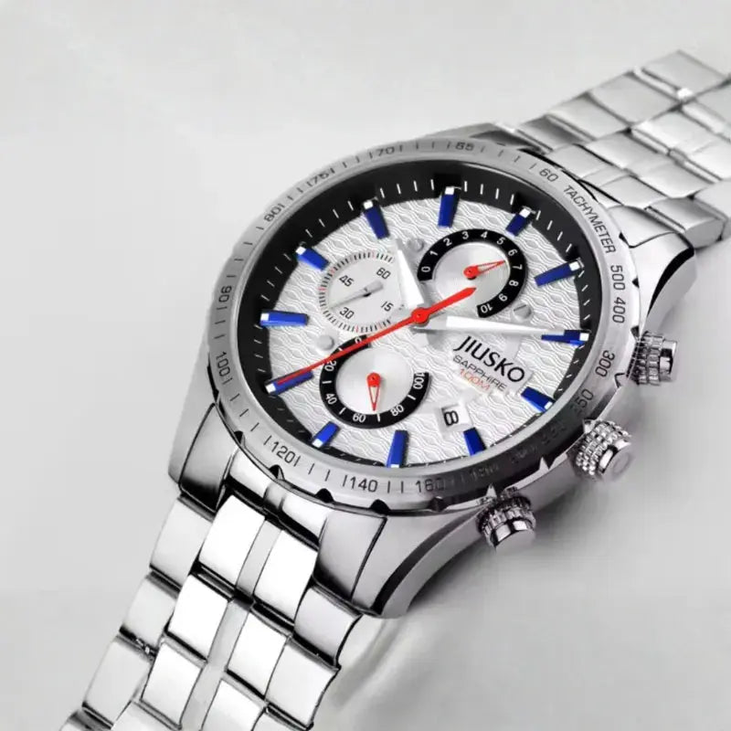 Silver watch with a detailed face on a light gray background