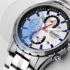 Close-up of a silver watch with a detailed face on a light gray background