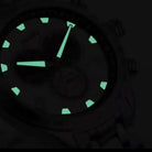 Watch face with glowing green markers on a dark background