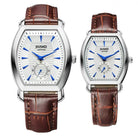 Two Jiusko watches with brown leather straps on a white background