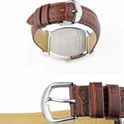Brown leather watch strap with silver buckle on a white background