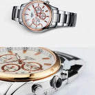 Two views of a silver and rose gold watch with a white face on a light gray background.